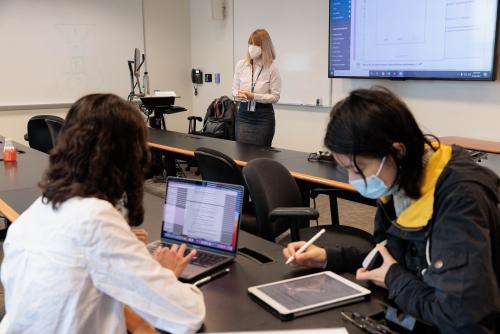 An EAP faculty member talking to a student at a table on the Mount Vernon Campus